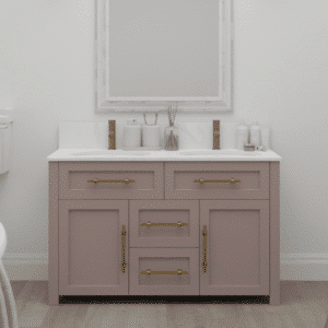 A pink vanity unit with double undermounted sinks, gold bar handles and solid countertop.